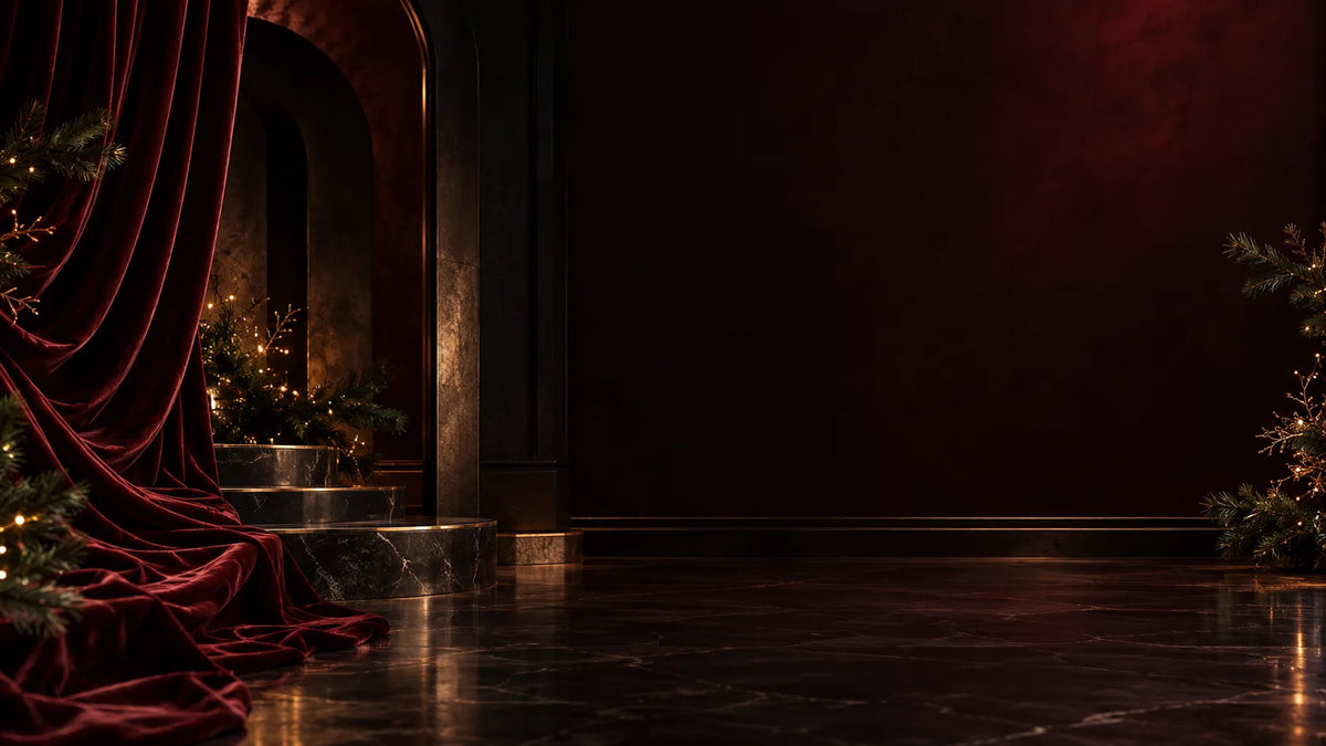 Burgundy Christmas editorial setting with pine branches and warm gold lights